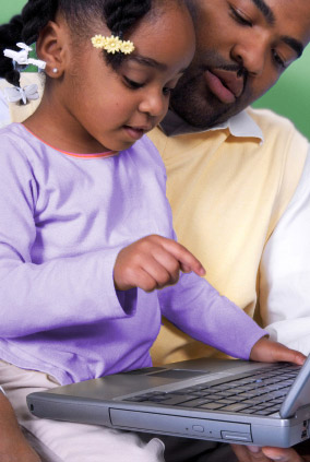 child using computer with parent