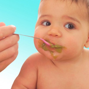 9-month-old enjoying creamed spinach